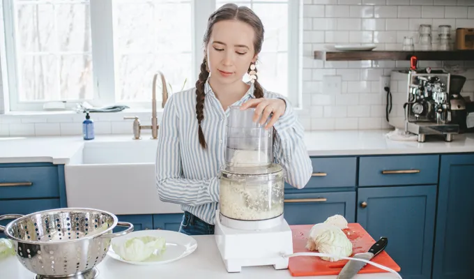 Shredding cabbage with a food processor.' title='Easy Spicy Sauerkraut Recipe