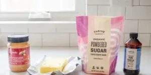 All of the ingredients needed to make no bake peanut butter balls on a white countertop with a window in the background. ' title='No Bake Peanut Butter Balls without Chocolate