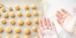 Rolling the peanut butter dough into balls and dipping your hands in powdered sugar.' title='No Bake Peanut Butter Balls without Chocolate