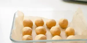 The finished peanut butter balls in a glass storage container. ' title='No Bake Peanut Butter Balls without Chocolate