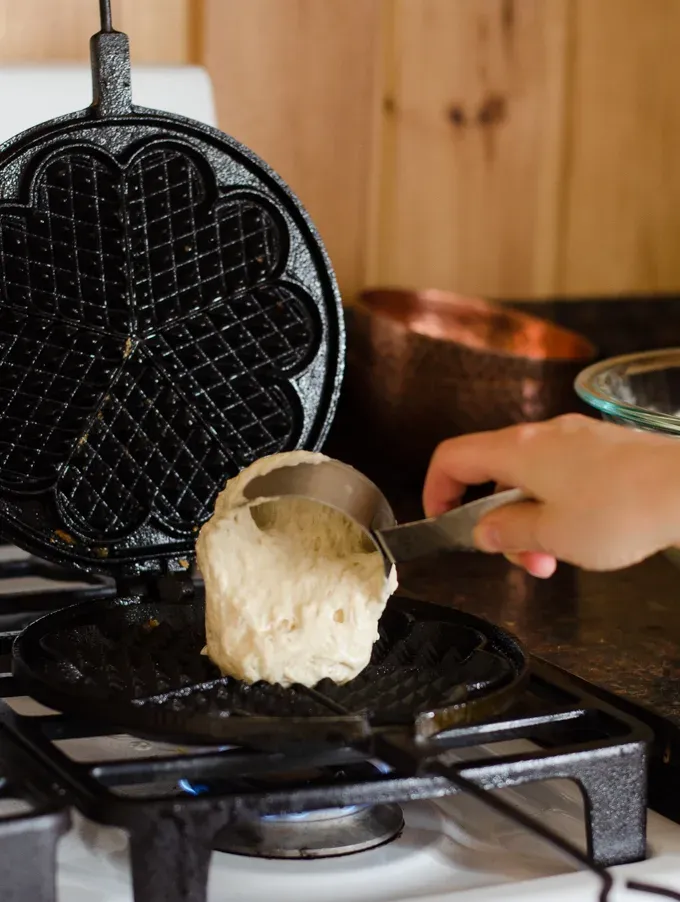 Adding the batter to the waffle iron.' title='Overnight Sourdough Waffles