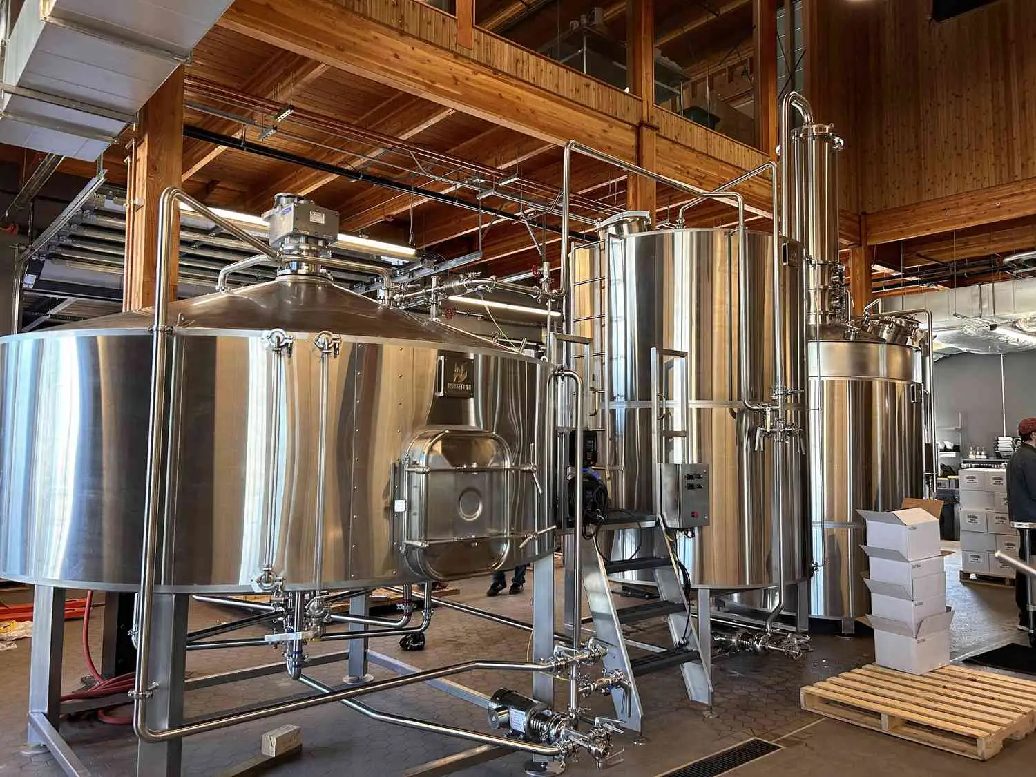 Two stainless steel tills in wood room at Wilderton distillery