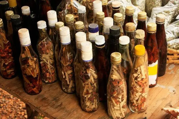 Various bottles filled with Mamajuana herbs, spices, and barks, some filled with liquid and others not