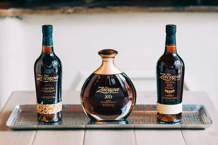 Three Ron Zacapa bottles lined up on a silver tray