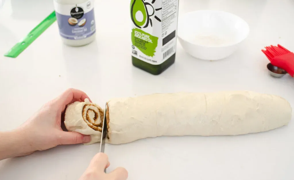 Slicing the dairy free cinnamon rolls with a serrated knife. ' title='Cinnamon Roll Recipe Without Milk