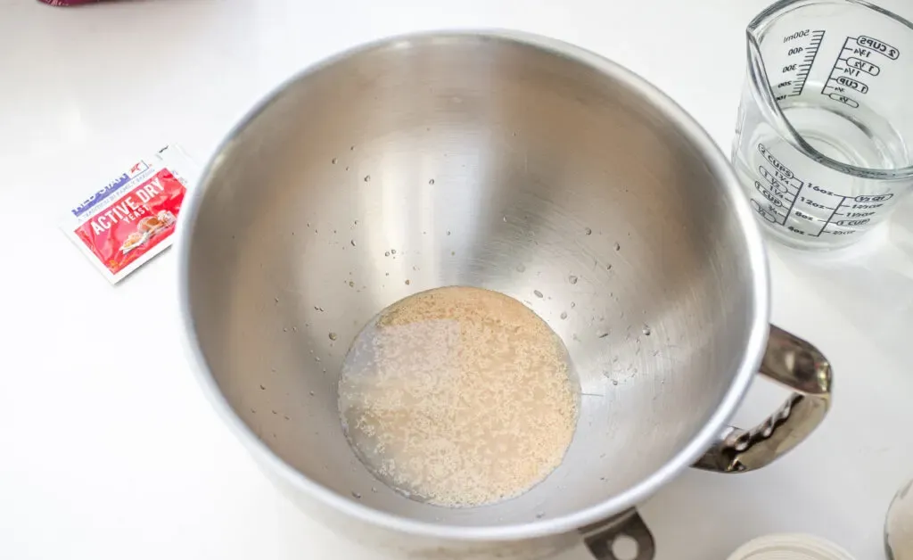 Activating the instant dry yeast in the bowl of a stand mixer.' title='Cinnamon Roll Recipe Without Milk