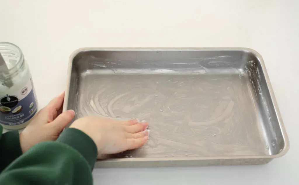 Greasing a 13x9 inch baking dish with coconut oil. ' title='Cinnamon Roll Recipe Without Milk