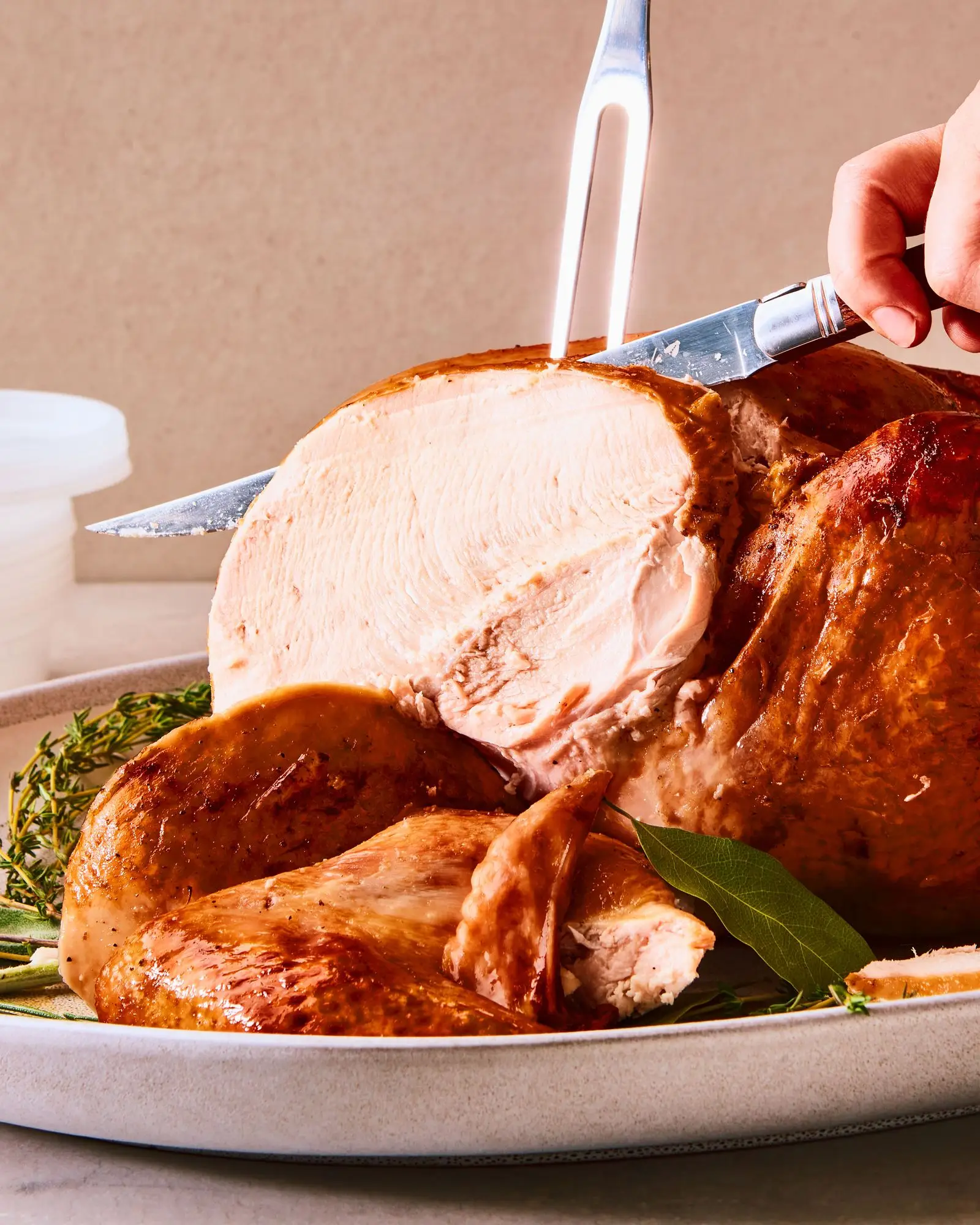 A stuffed turkey being sliced on a serving platter.
