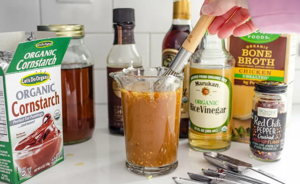 Whisking together the ingredients for the stir-fry sauce for a healthy chicken stir-fry. ' title='Healthy Chicken Stir Fry Recipe