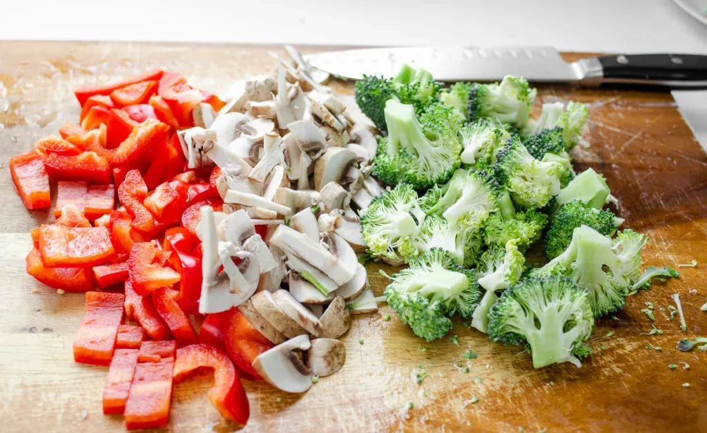 Red bell pepper mushrooms and broccoli sliced and prepared for a stir-fry. ' title='Healthy Chicken Stir Fry Recipe