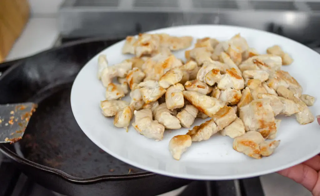 removing the cooked chicken to a plate. ' title='Healthy Chicken Stir Fry Recipe