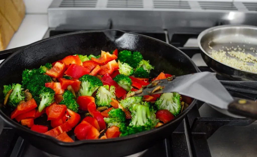 Adding the red bell peppers to the stir fry. ' title='Healthy Chicken Stir Fry Recipe