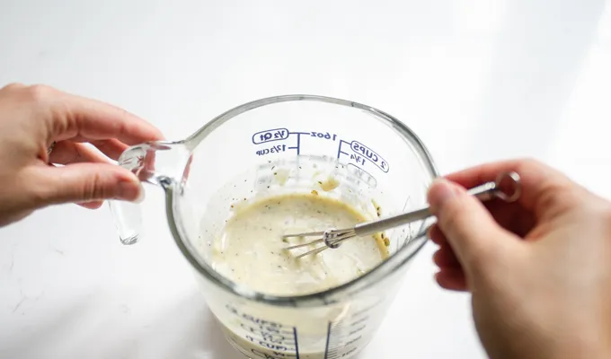 Whisking together the ingredients for the dressing for the BLT bowtie pasta salad.' title='BLT Bowtie Pasta Salad