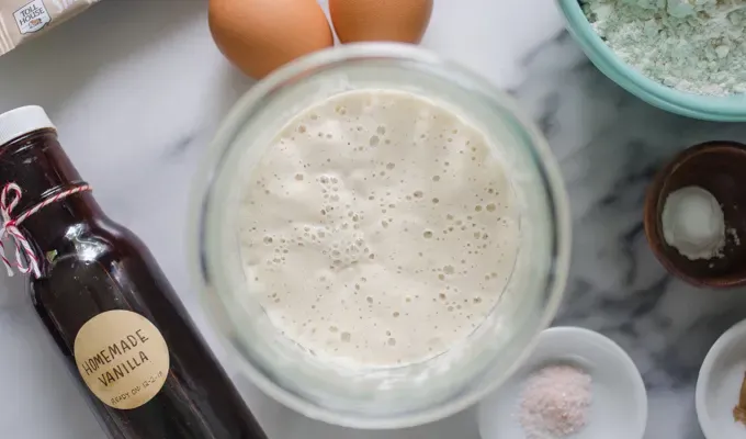 Active sourdough starter on a marble surface.' title='Sourdough Banana Bread