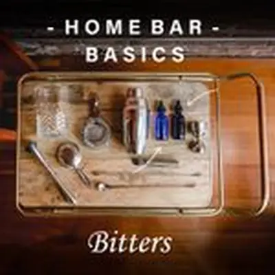 A collection of bar equipment rests on an elegant wooden bar tray with brass handles. The tray holds a shaker, mixing glass, two strainers, two stoppered blue bottles, a jigger, peeler, two bar spooners, and a muddler. The words Home Bar Basics and Bitters are printed above and below the tray.