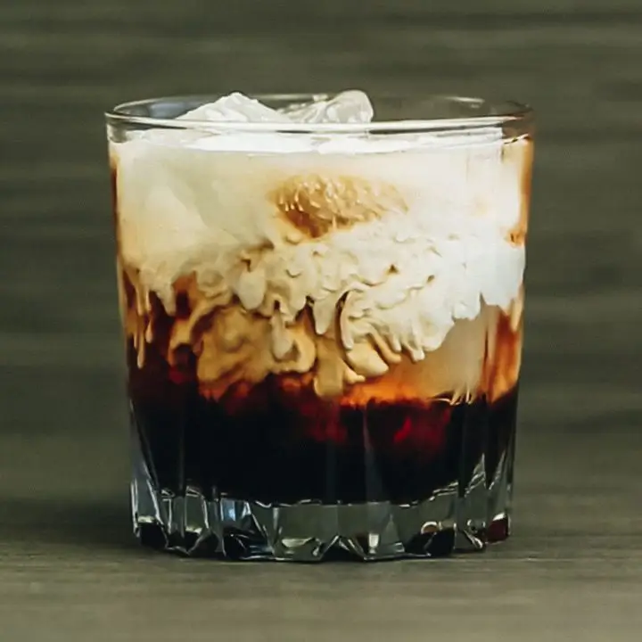 A close-up of a White Russian in a beveled rocks glass