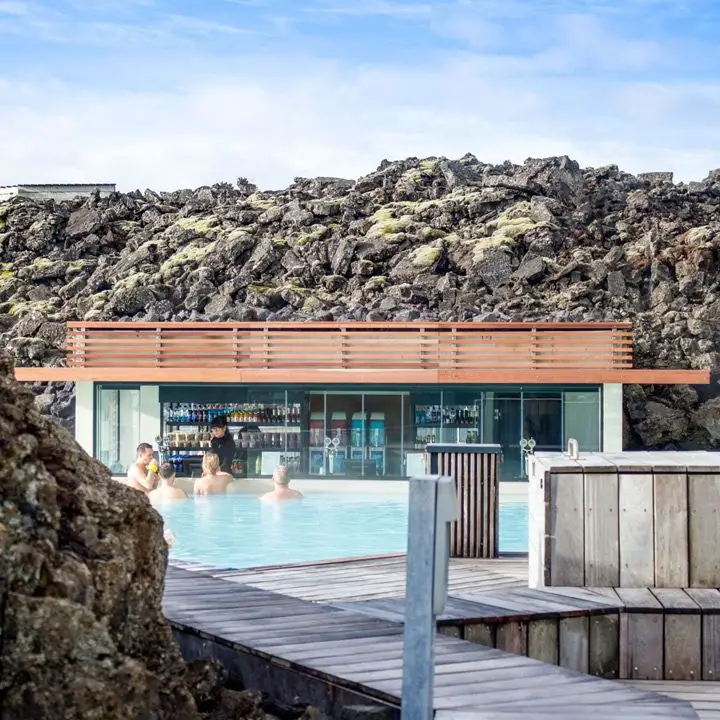 Blue Lagoon swim-up bar in Iceland. Volcanic rock peers over all sides of this modernist swim-up bar