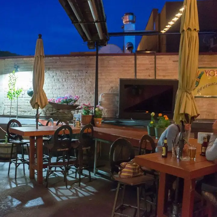 No Name Saloon. a large interconnected communal table is in the middle of the open-air patio