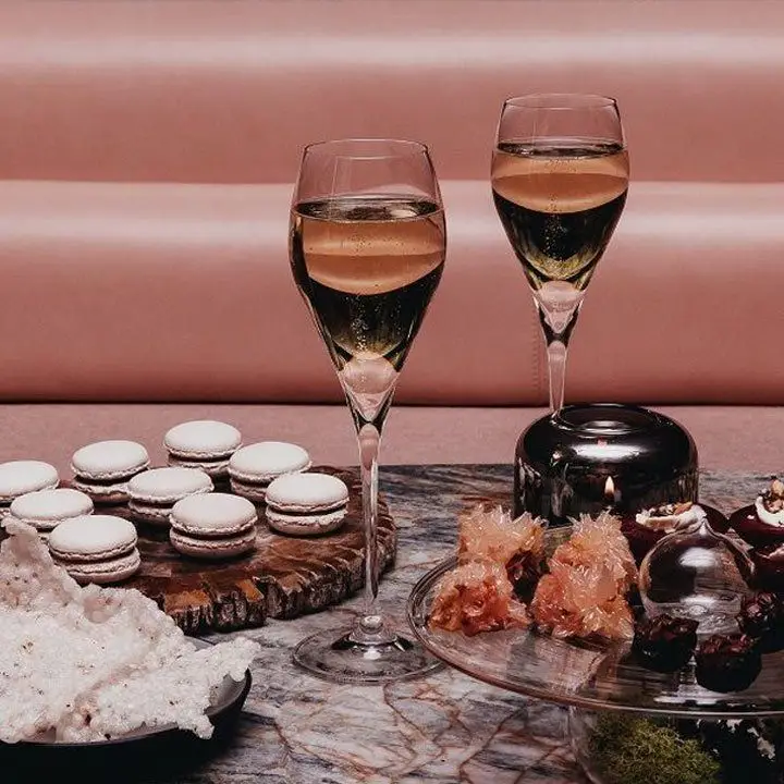 Two Champagne flutes with macarons at Botanist bar at Fairmont Pacific Rim