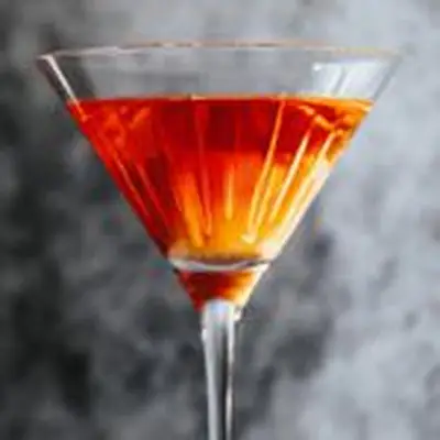 Red-orange El Presidente cocktail in a stemmed glass