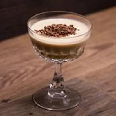 Mudslide cocktail in coupe glass garnish with chocolate flakes