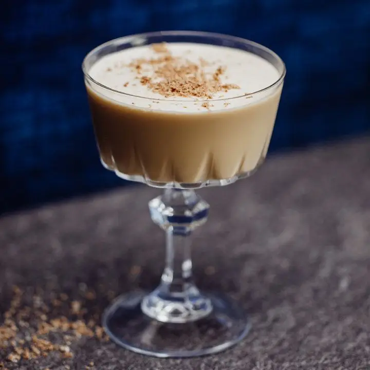 A frothy Mudslide cocktail in a glass coupe