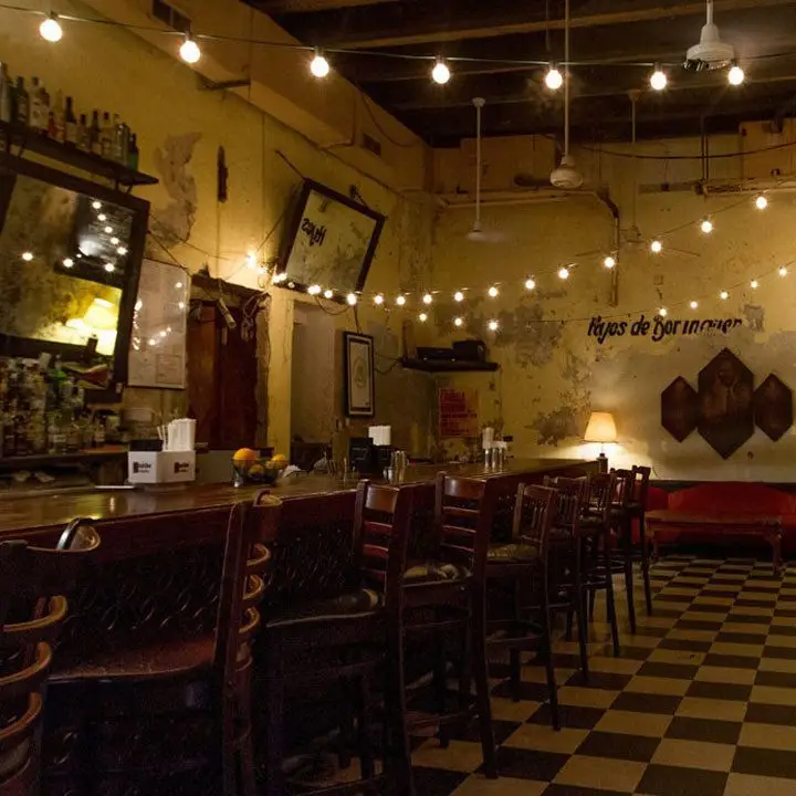 La Factoria San Juan. string lights are strung over the room and the paint is chipping from the walls in the great Viejo San Juan way