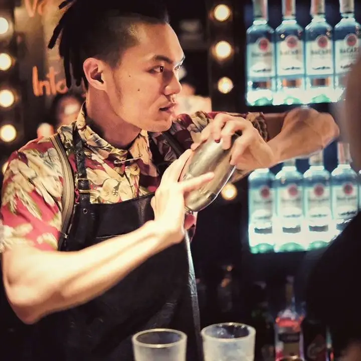 GN Chan shakes a cocktail at Double Chicken Please in New York City