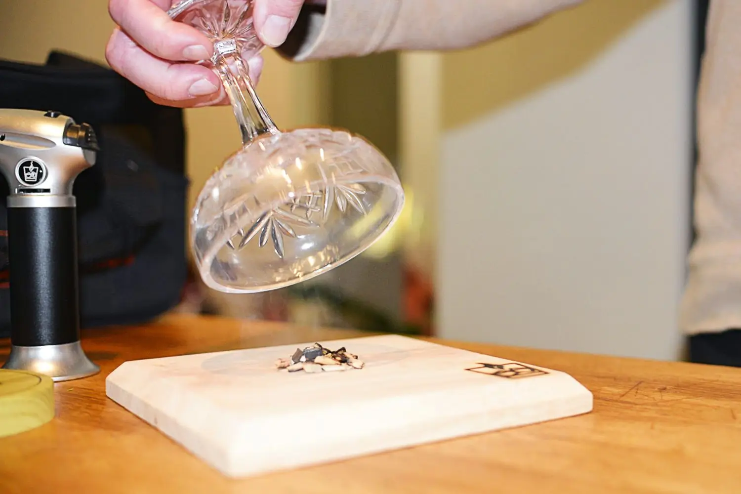 Hand holding glass used with Smokeboards Kit