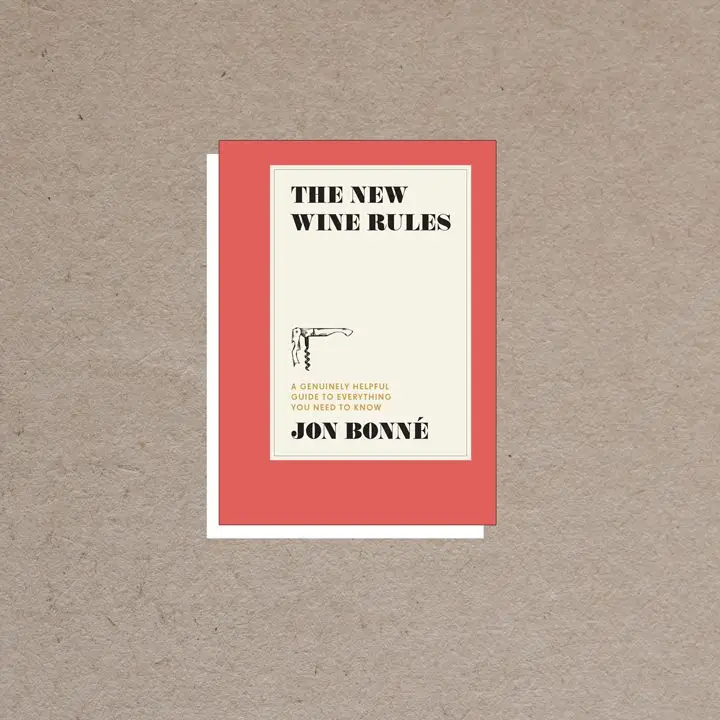 The New Wine Rules cover, dark coral border with offset ivory rectangle in center containing all-caps black and gold text and a small corkscrew illustration