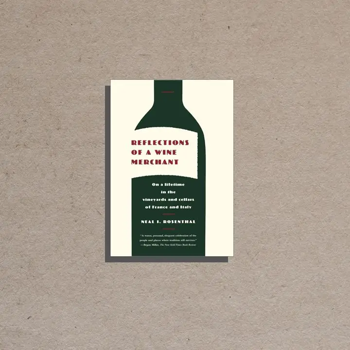 Reflections of a Wine Merchant cover, off white background and offset label on a large solid dark green vertical wine bottle containing burgundy and white text