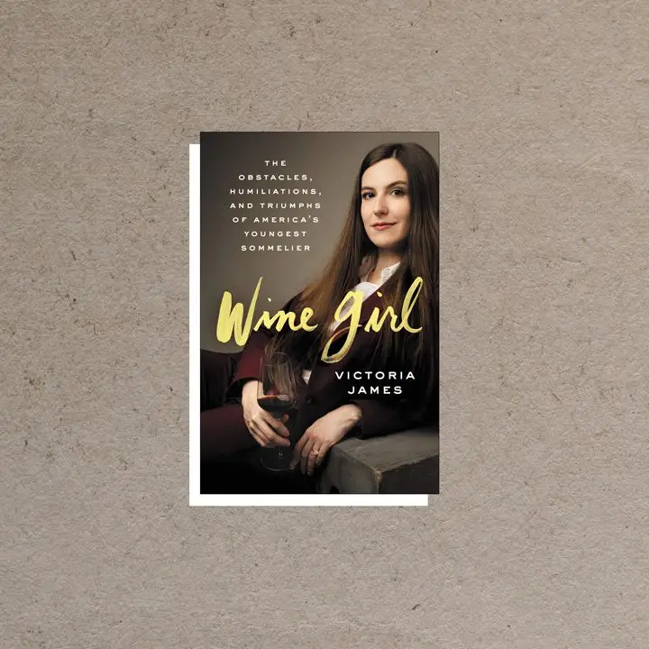Wine Girl cover featuring portrait of author and a glass of wine against a dark gray background, overlaid with white and yellow text