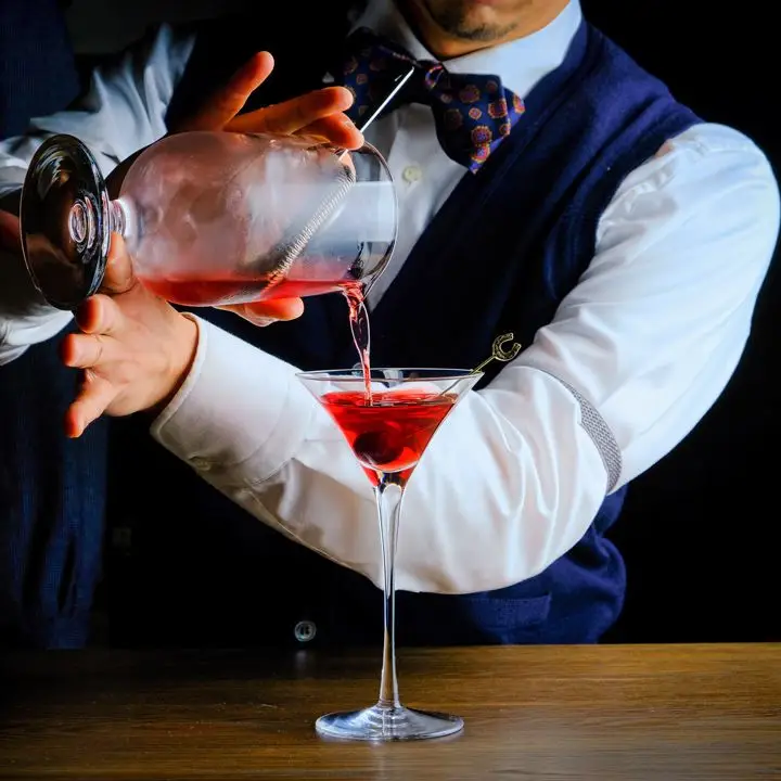 Takuma Wantanabe pours a cocktail at Martinyâs in New York City