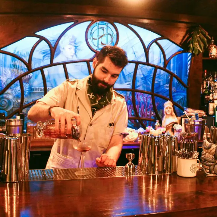Head bartender Stephen Bielawski pours a cocktail at Sunken Harbor Club in Brooklyn, New York