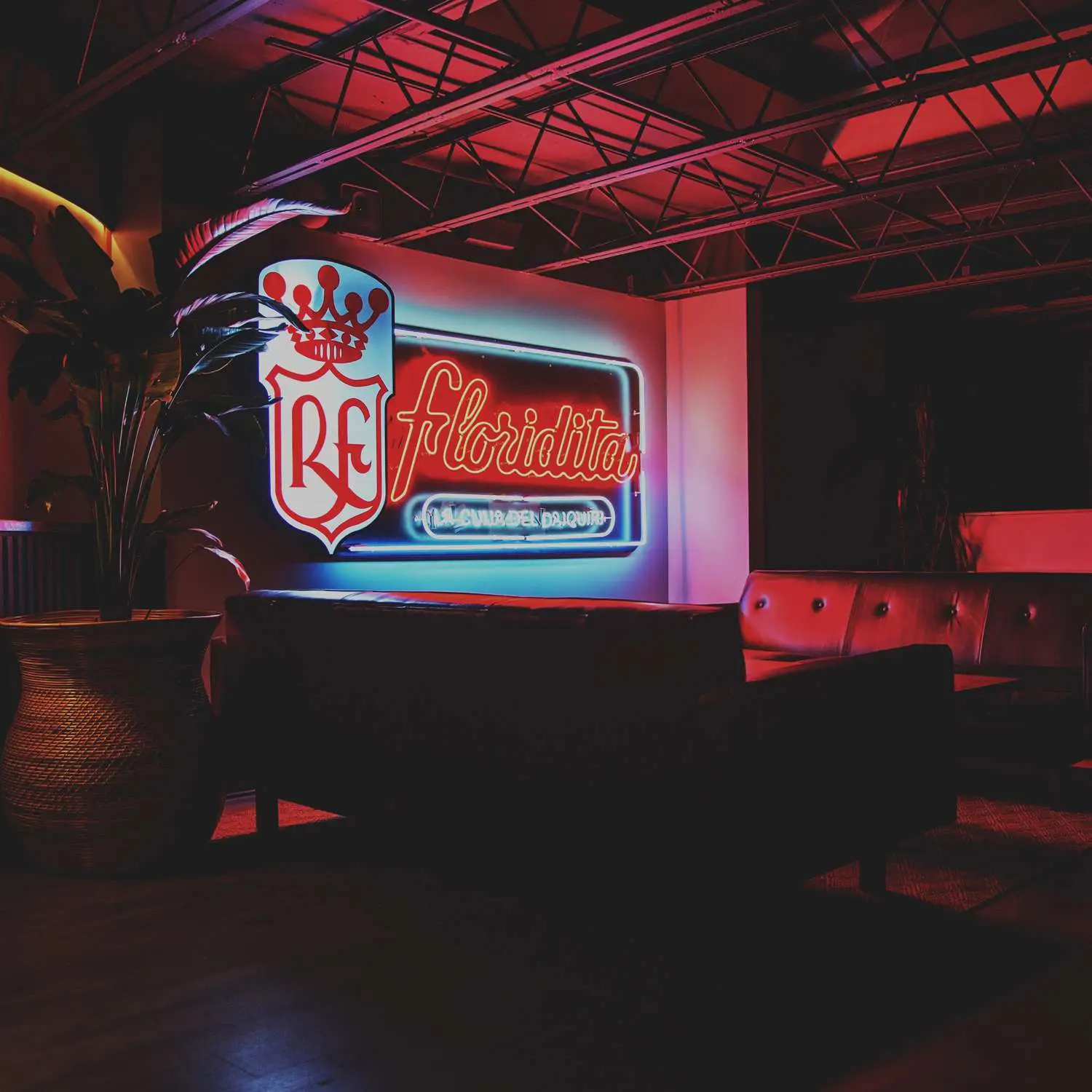 Interior of Refuge in Houston, Texas, showing leather couches and replica Floridita neon sign