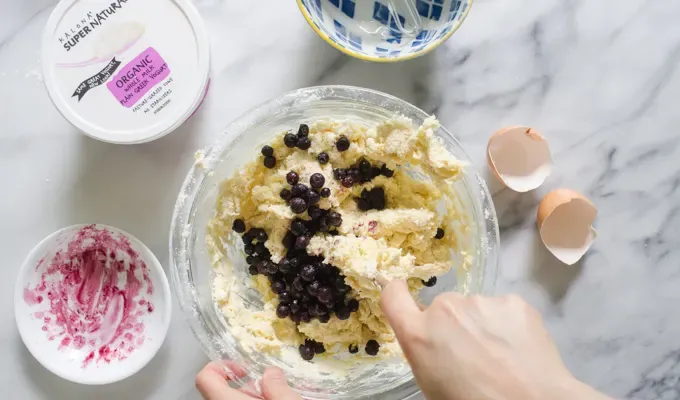 Gently mixing the scone dough to incorporate the blueberries.' title='Easy Blueberry Greek Yogurt Scones Recipe with Lemon