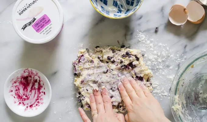 Patting the dough out into a rectangle on a marble surface.' title='Easy Blueberry Greek Yogurt Scones Recipe with Lemon