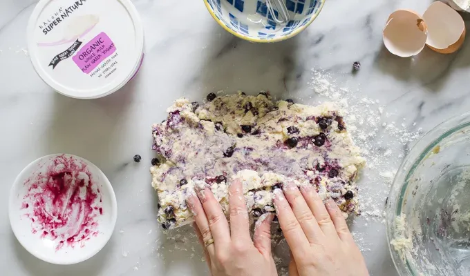 Rolling the scone dough up jelly-roll style.' title='Easy Blueberry Greek Yogurt Scones Recipe with Lemon