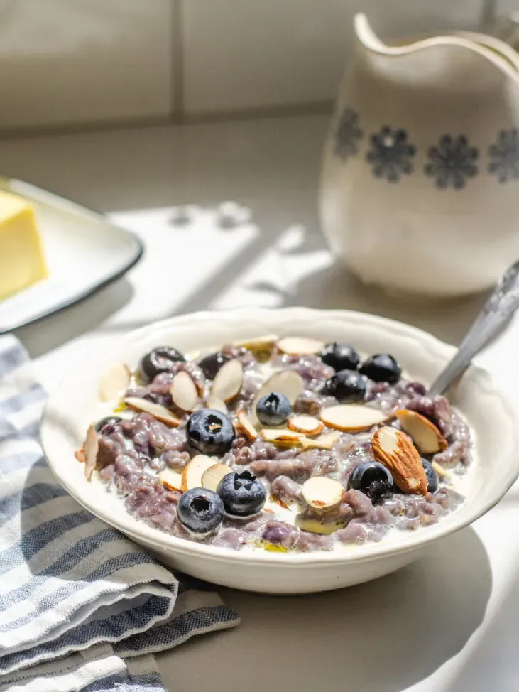 A bowl of blueberry oatmeal with fresh blueberries and sliced almonds on top.' title='Blueberry Oatmeal Recipe