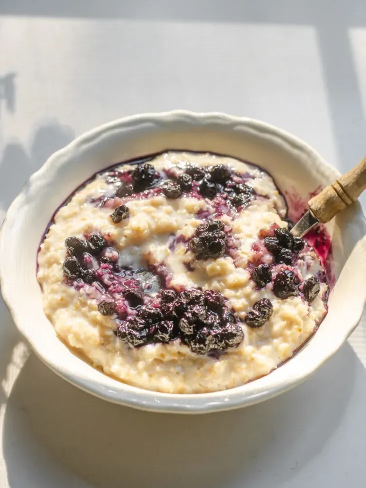 A bowl of oatmeal with blueberry compote swirled in.' title='Blueberry Oatmeal Recipe
