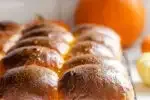 Pumpkin sourdough dinner rolls on a black wire cooling rack.' title='Pumpkin Sourdough Dinner Rolls