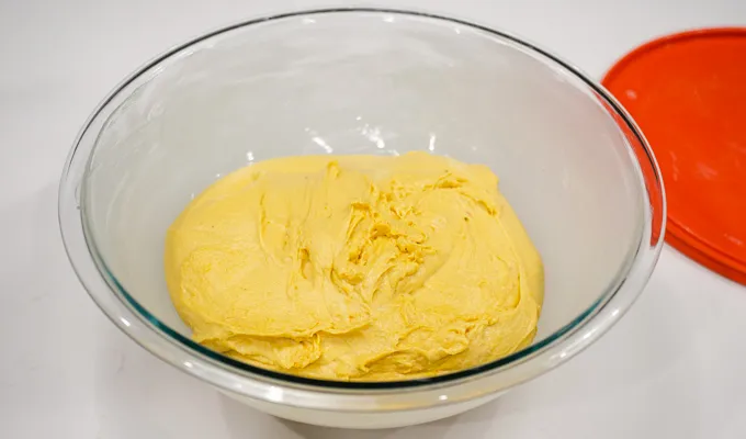 The kneaded dough in a buttered mixing bowl.' title='Pumpkin Sourdough Dinner Rolls