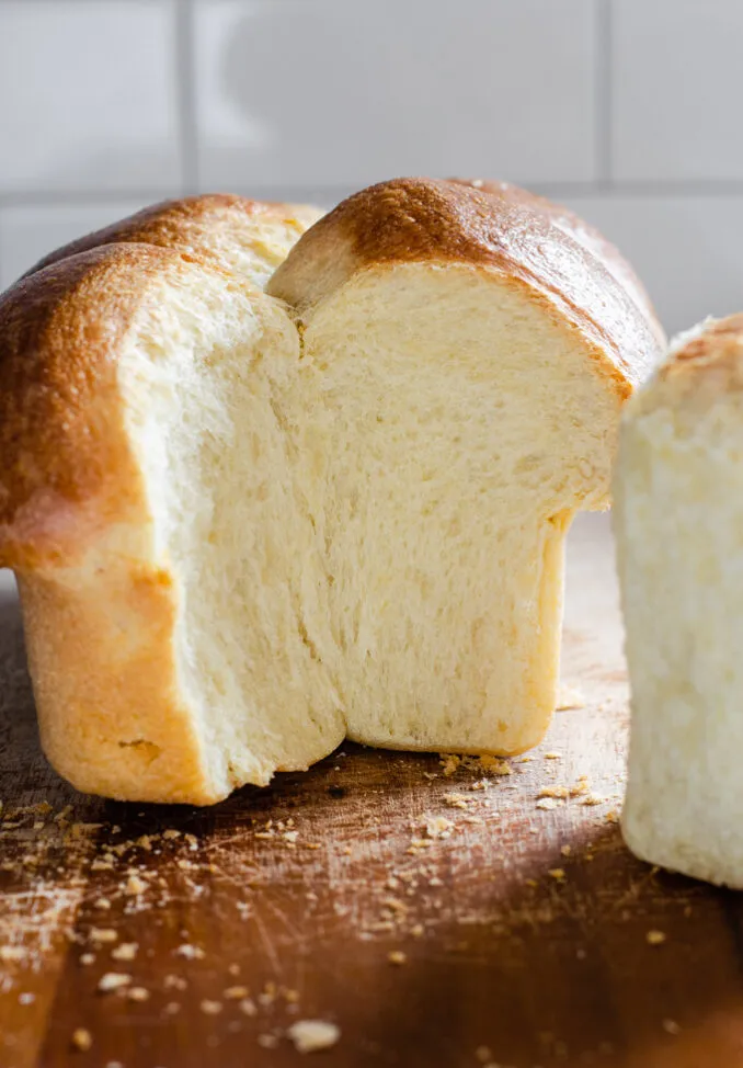 Sourdough brioche bun bread with a section taken out.' title='Sourdough Brioche