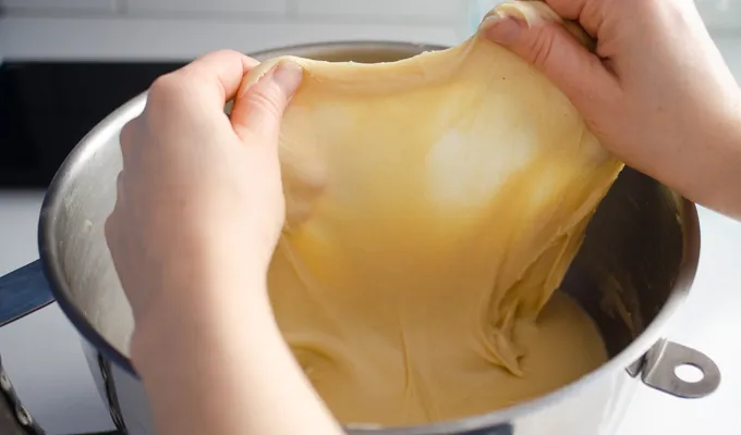 Doing the windowpane test on the sourdough brioche dough.' title='Sourdough Brioche