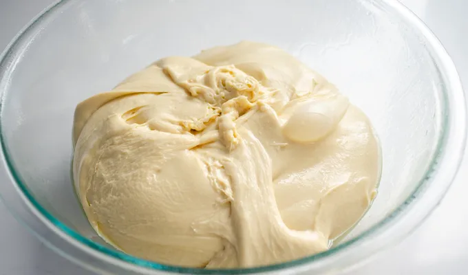 The ball of dough placed in a greased bowl.' title='Sourdough Brioche