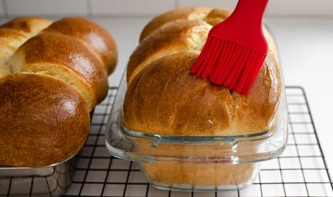 Brushing the warm loaf with the vanilla simple syrup.' title='Sourdough Brioche