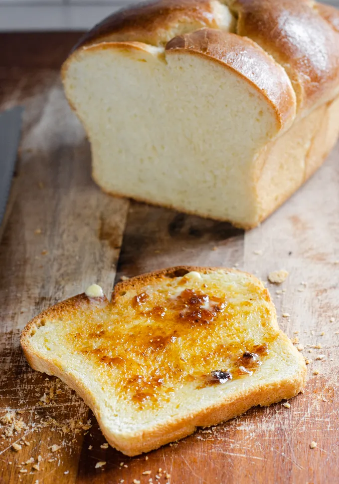 A toasted slice of sourdough brioche bread with melted butter and fig jam.' title='Sourdough Brioche