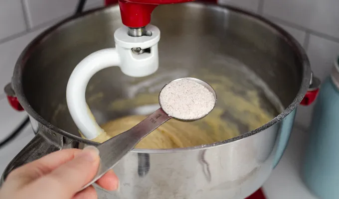 Adding the salt to the sourdough brioche dough.' title='Sourdough Brioche