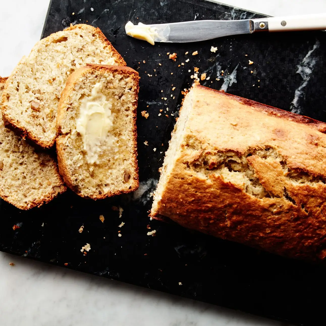 Our best banana recipes banana bread on a cutting board.