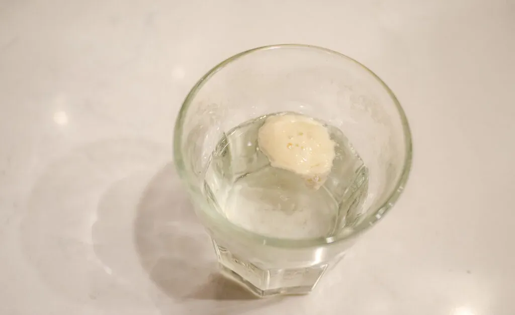 Performing the float test on a sourdough starter.' title='Healthy Whole Wheat Sourdough Sandwich Bread